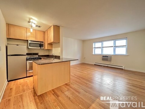 A kitchen with wooden floors and a large island.