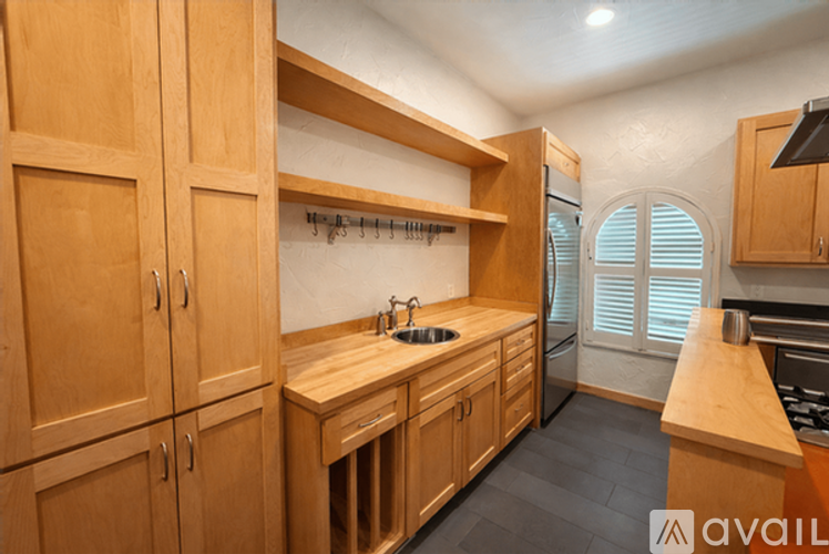A kitchen with wooden cabinets and a countertop.