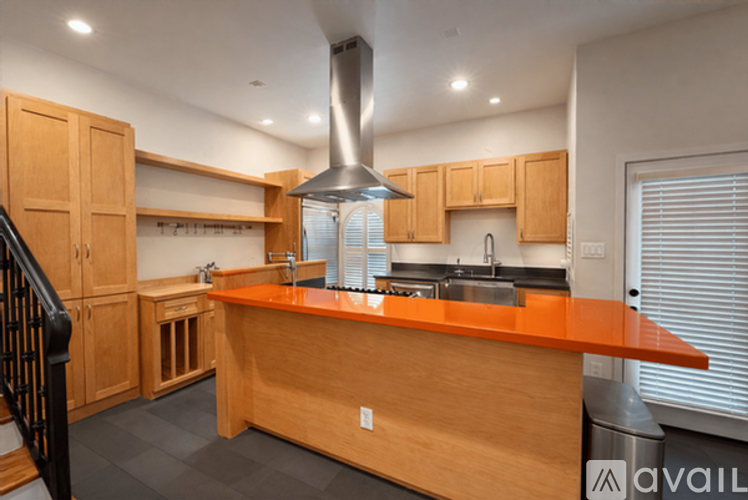 A kitchen with wooden cabinets and a central island.