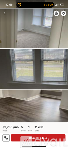 A room with a large window overlooking a grassy area.