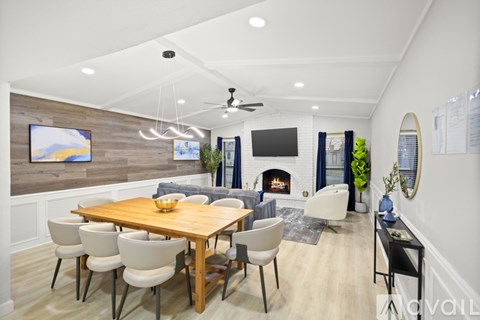 A modern dining room with a wooden table and chairs.