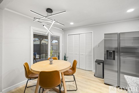 A modern kitchen with a round table and chairs.