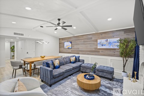 A modern living room with a grey sofa and a wooden coffee table.