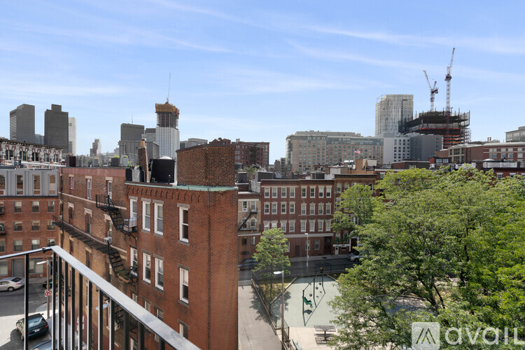 A view of a cityscape from a high vantage point, with a mix of residential and commercial buildings.