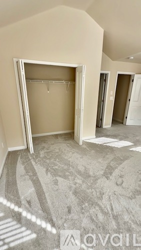 A room with a carpeted floor and a large open door.