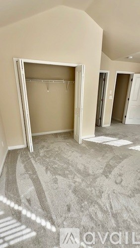 A room with a carpeted floor and a large open door.