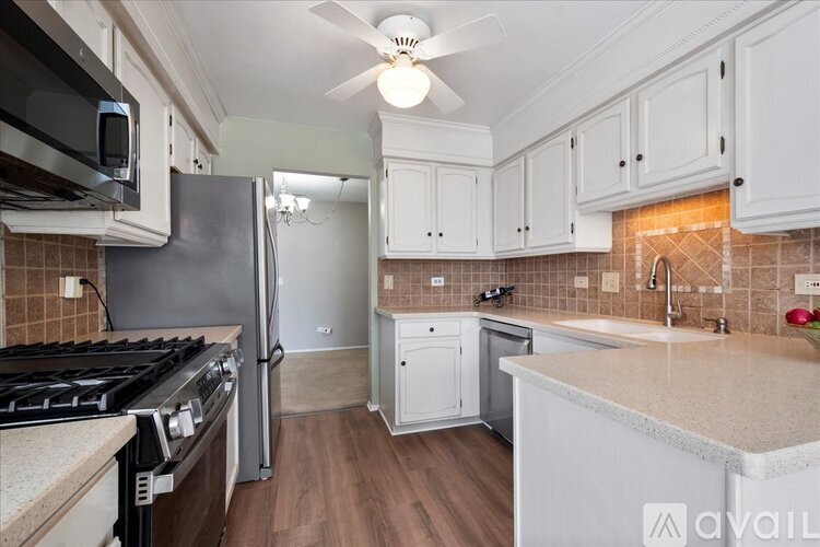 A kitchen with a black stove top oven and a black refrigerator.