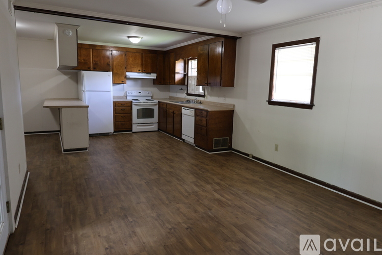 A kitchen with wooden cabinets and a white refrigerator.