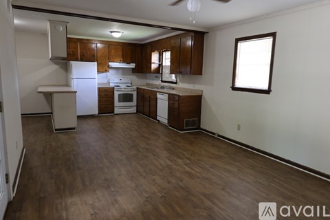 A kitchen with wooden cabinets and a white refrigerator.