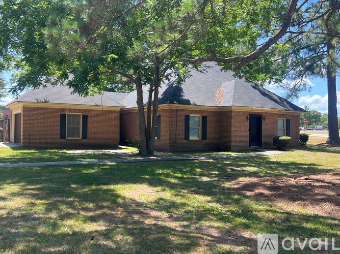 A house with a tree in front of it.