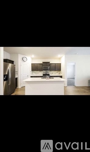 A kitchen with a white countertop and black cabinets.