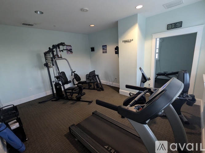 A gym with treadmills, exercise bikes, and other equipment.