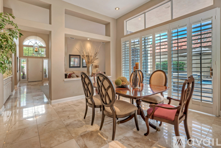 A dining room with a table set for four.