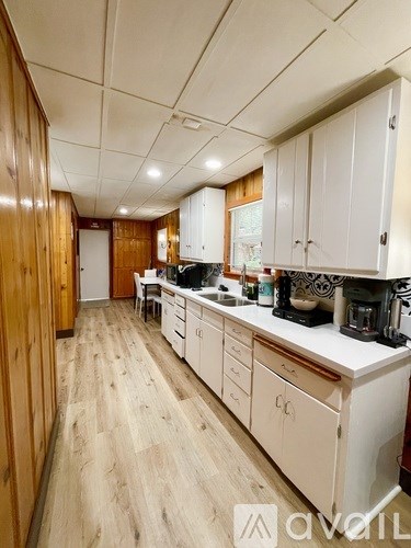 A kitchen with wooden cabinets and a white countertop.