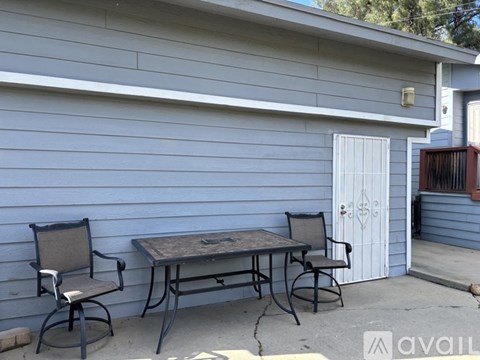 A patio with a table and two chairs.