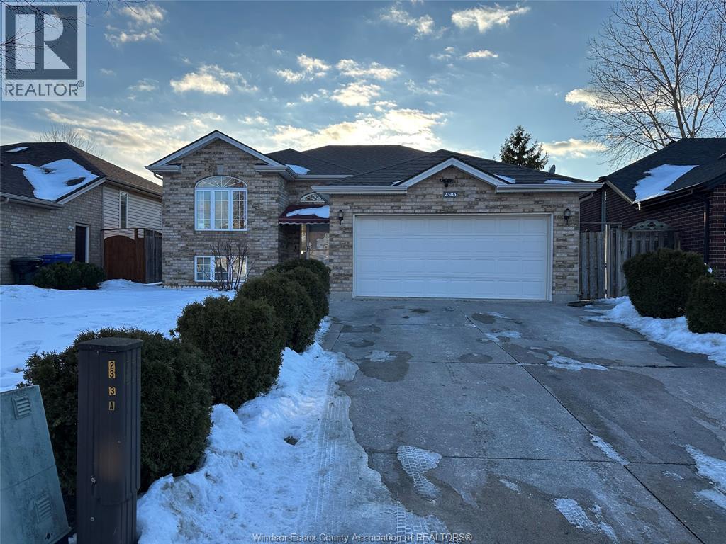 A house with a snow-covered driveway and a mailbox in front.