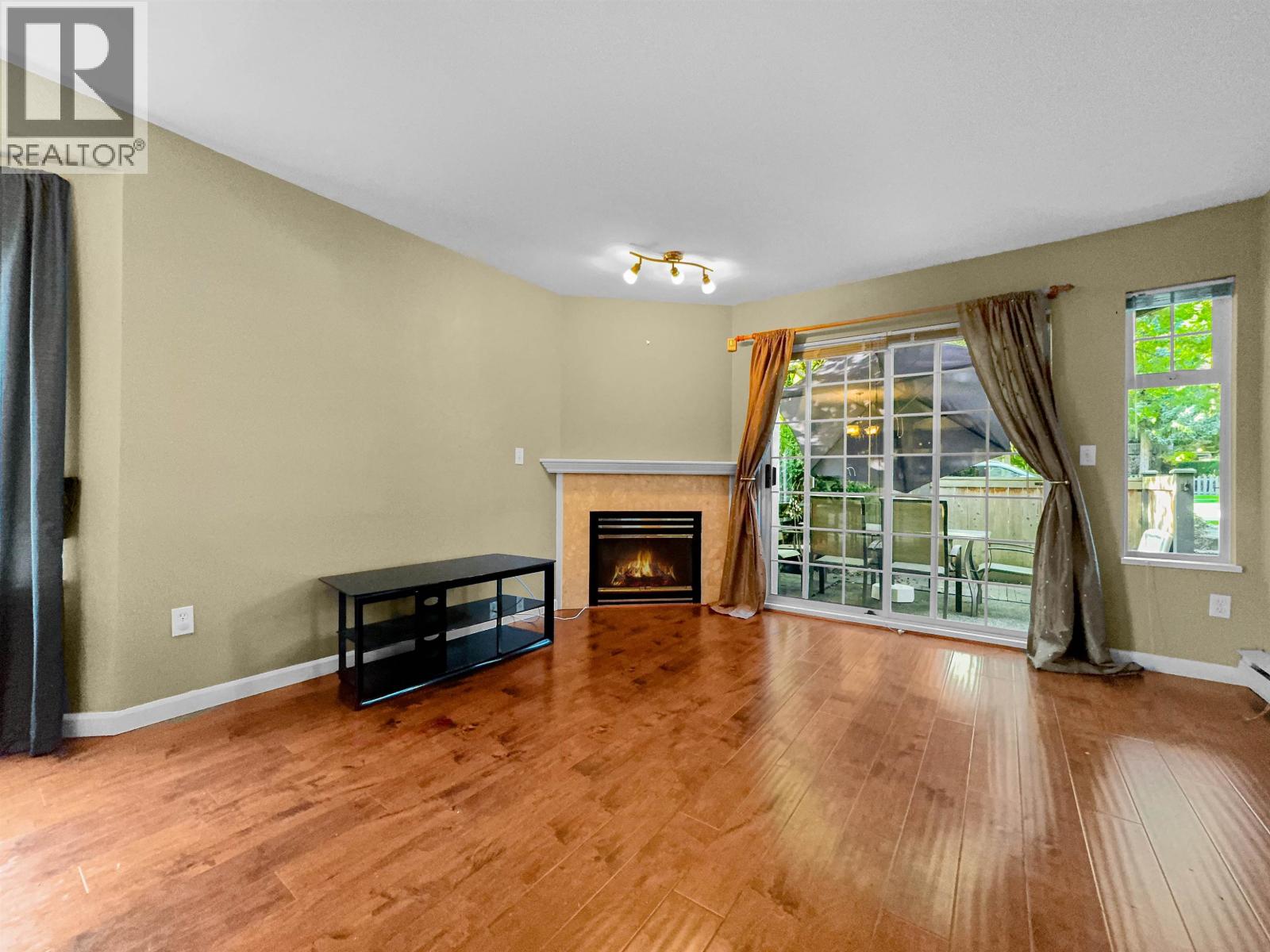 A living room with a fireplace and sliding glass doors.