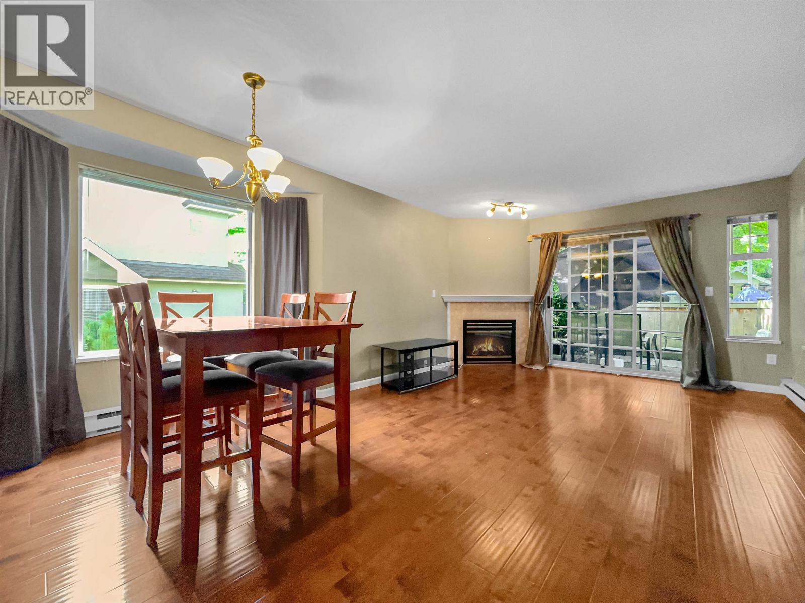A dining room with a wooden table and chairs.