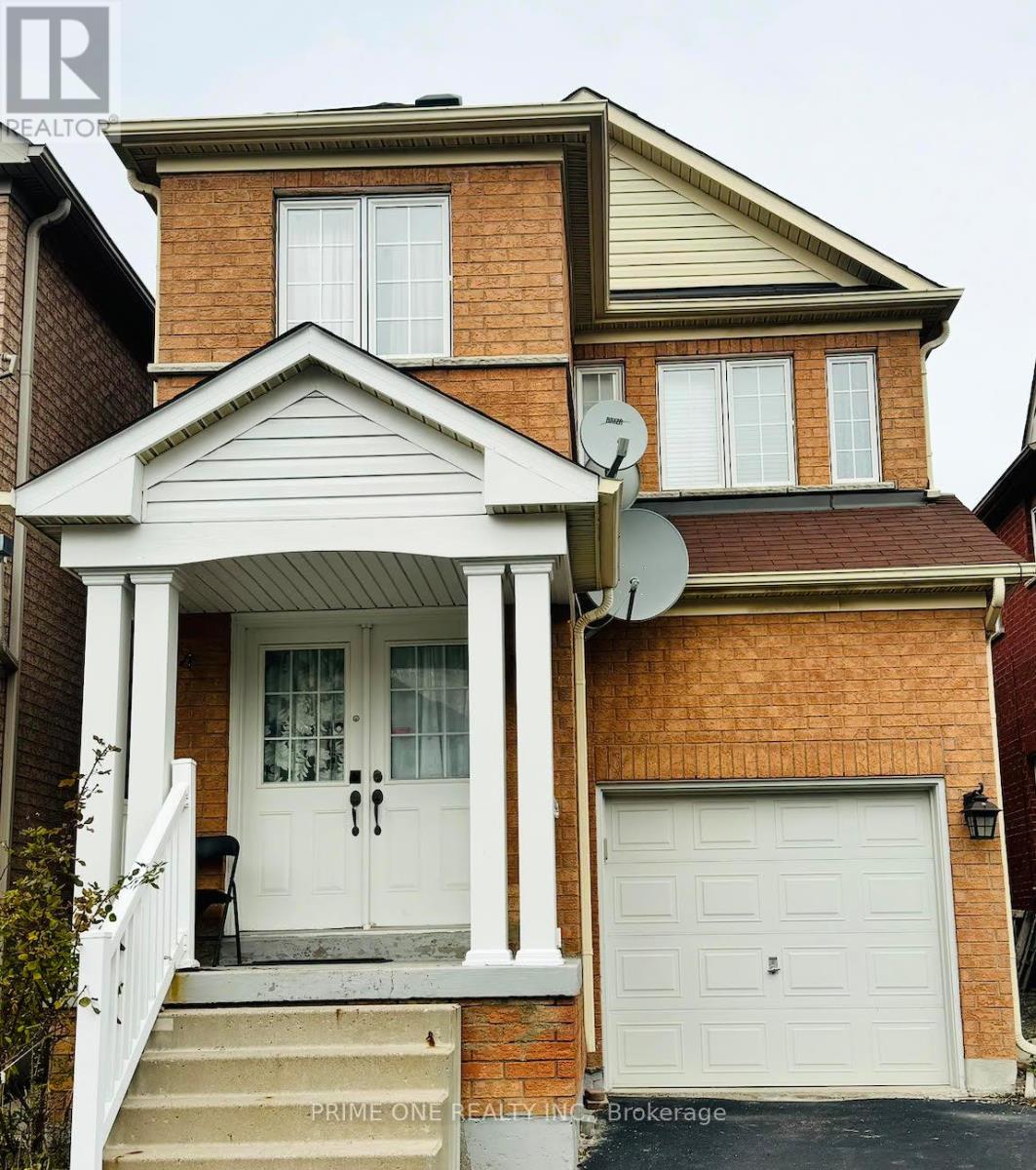 A house with a white door and a garage door.