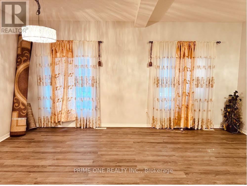 A room with a large window covered in curtains.