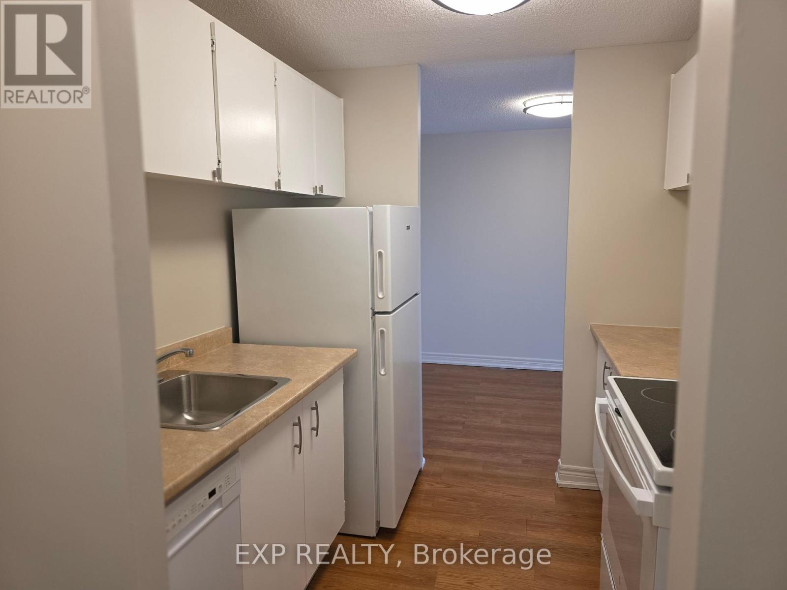A kitchen with white cabinets and a sink.