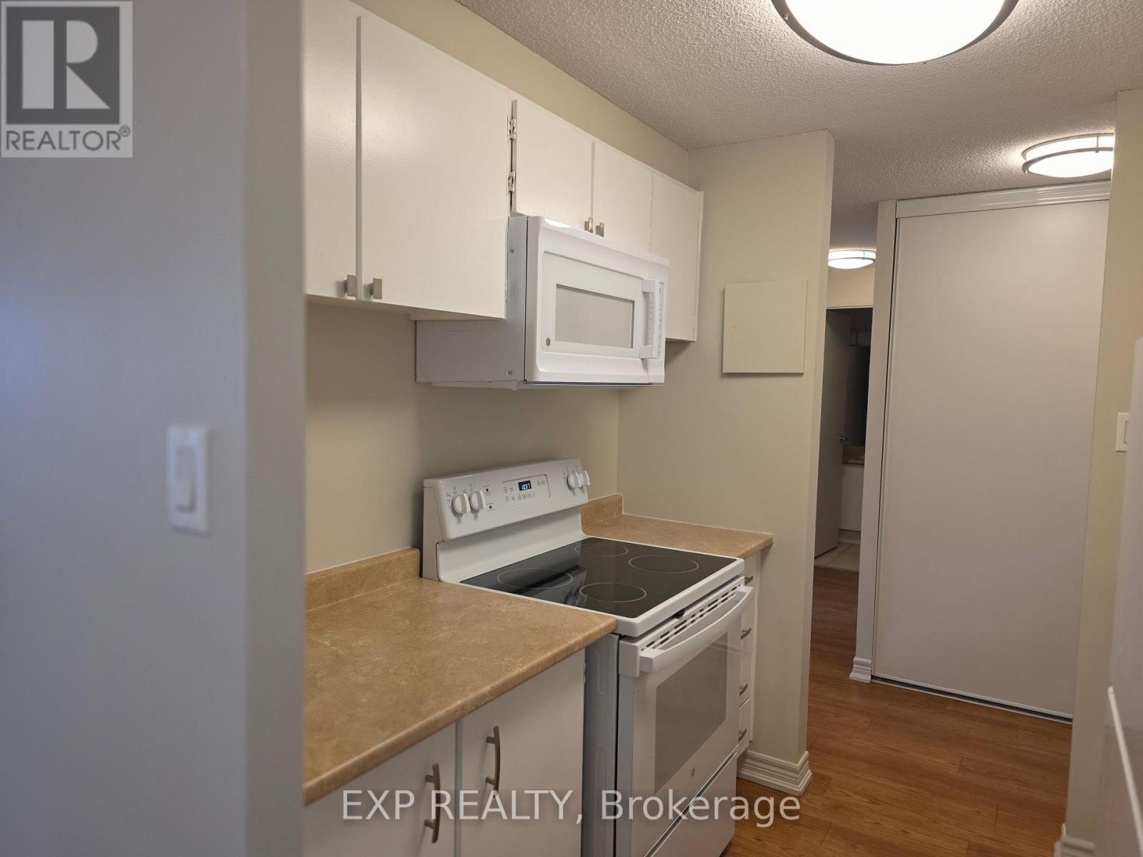 A kitchen with a stove top oven and microwave.