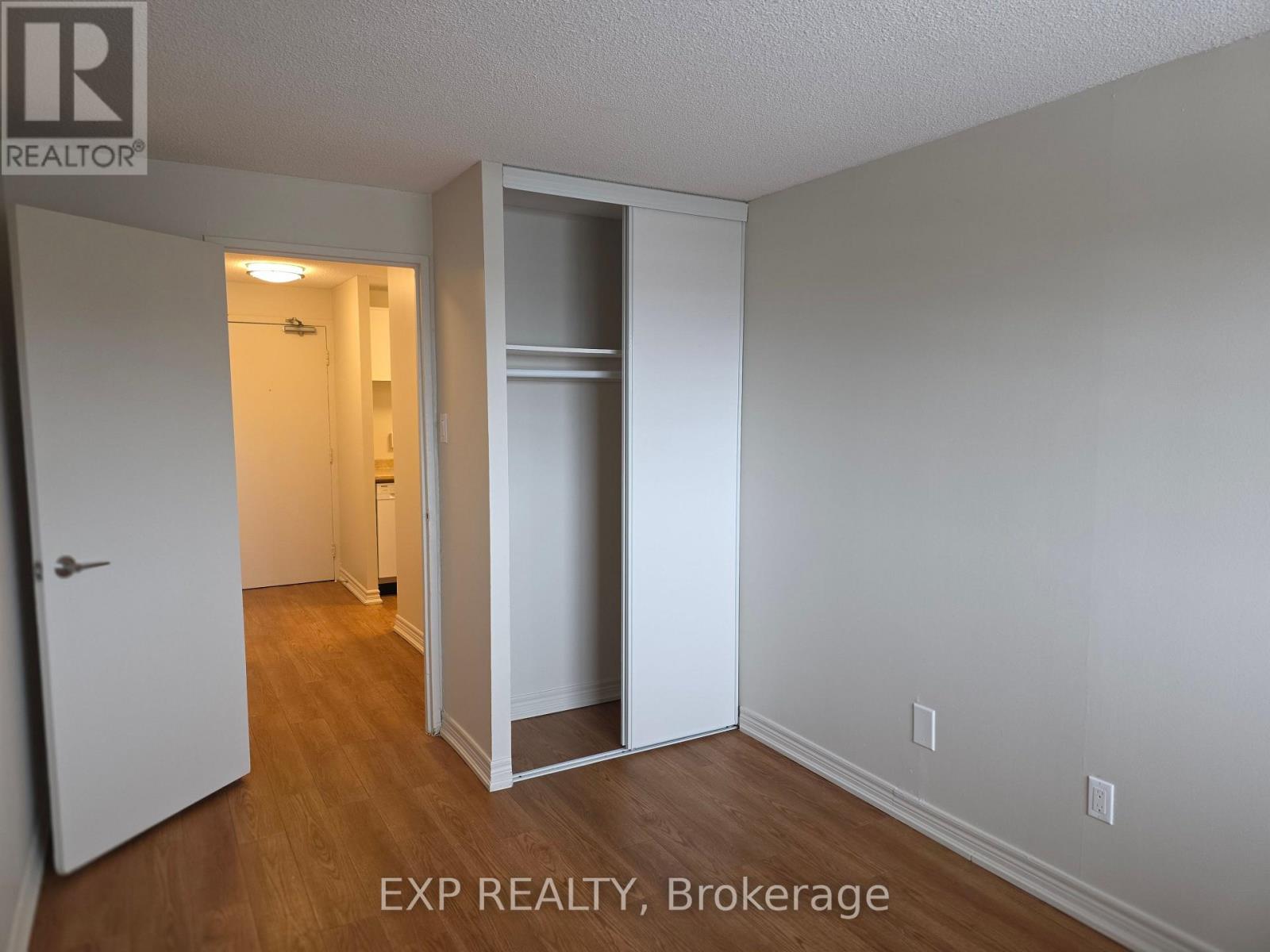 A room with EXP REALTY, Brokerage written on the wall.