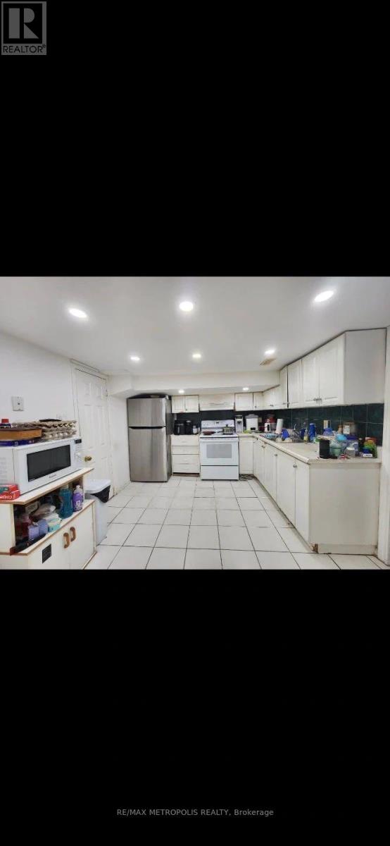 A well-lit, clean kitchen with white cabinets and appliances.