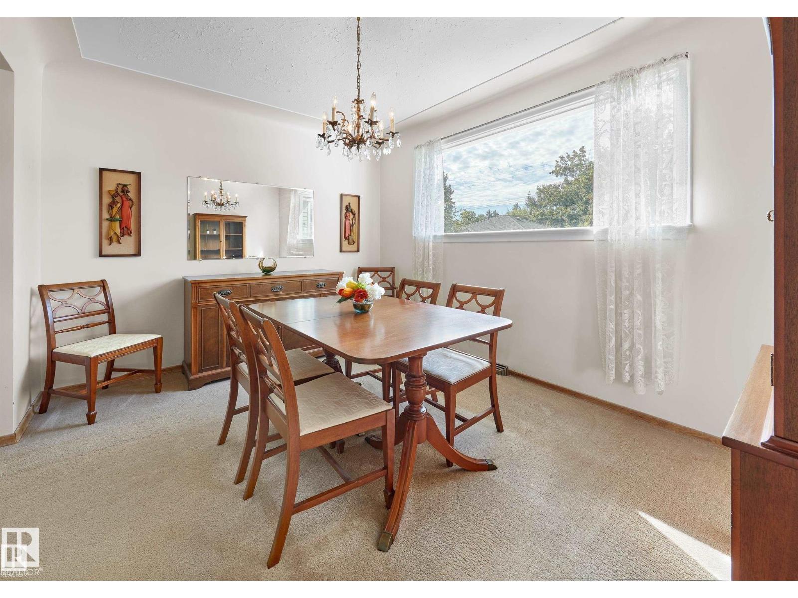A dining room with a wooden table and chairs.