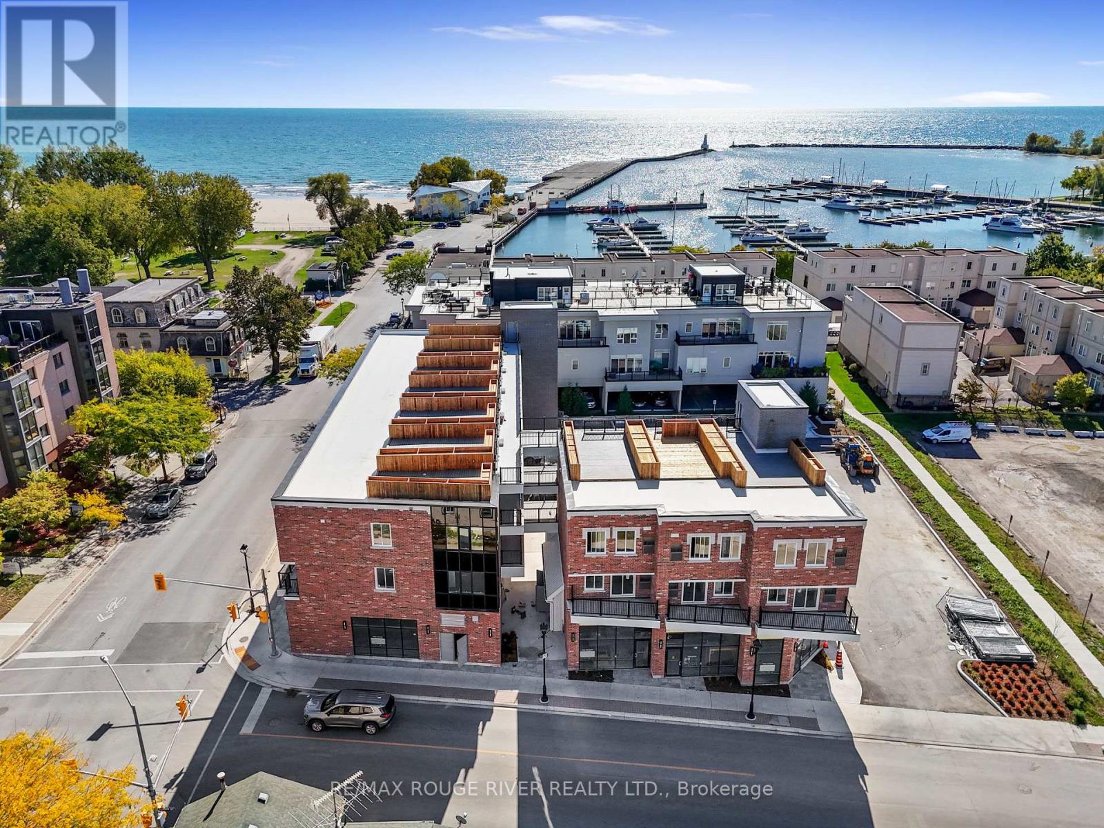 A real estate company logo is displayed on an aerial view of a waterfront property.