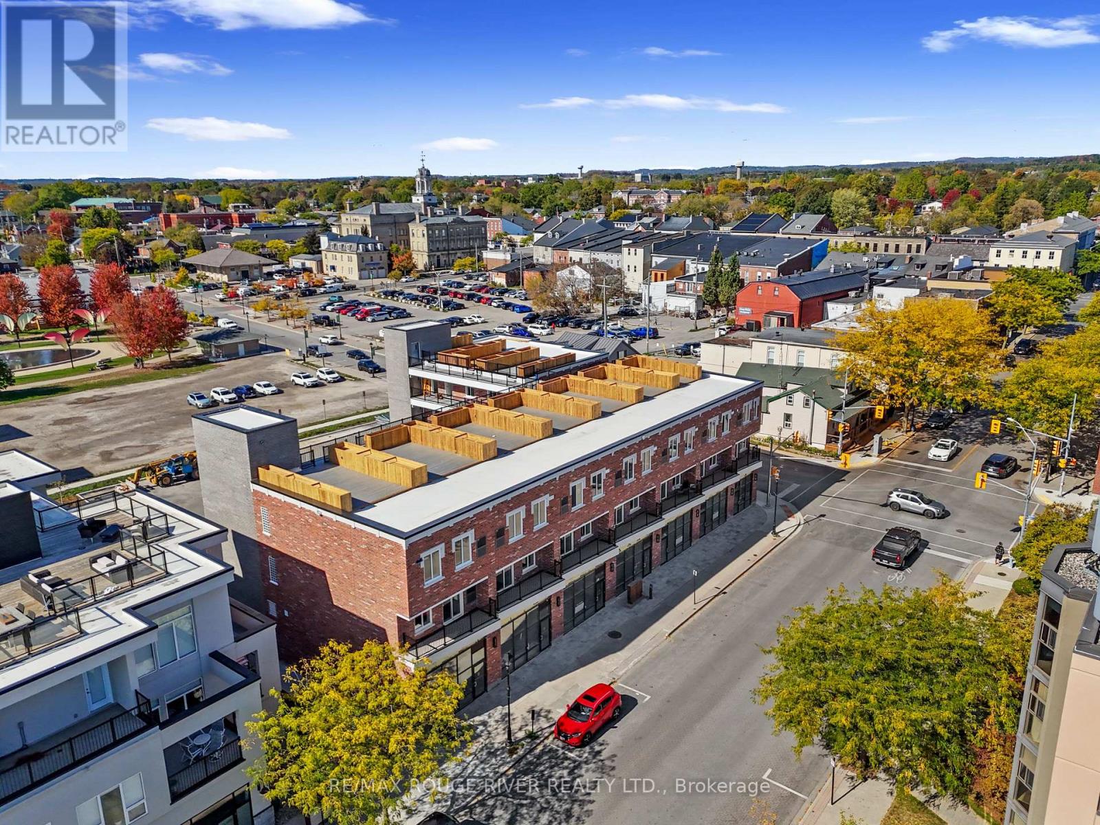 A city street with cars and buildings with the words REALTOR on them.
