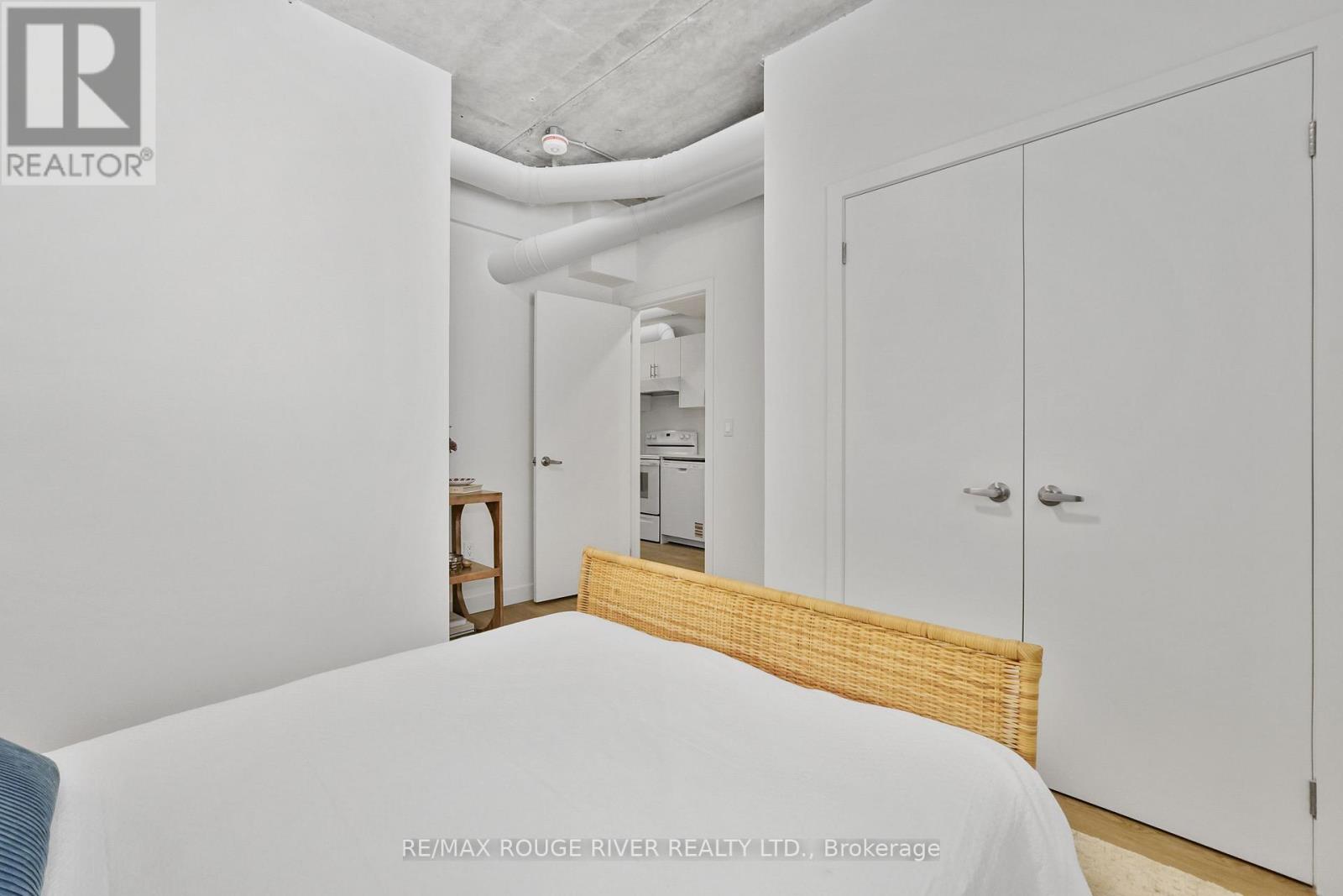 A bedroom with a bed, wardrobe and a desk.