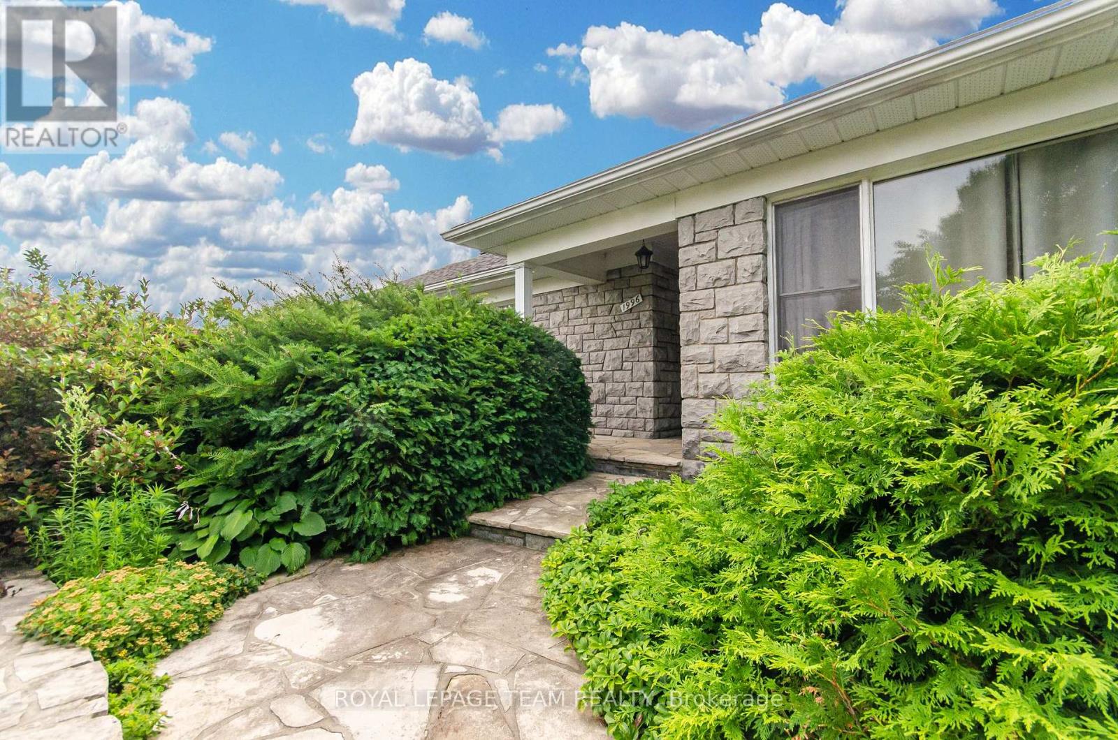 A house with a stone pathway leading to the front door.