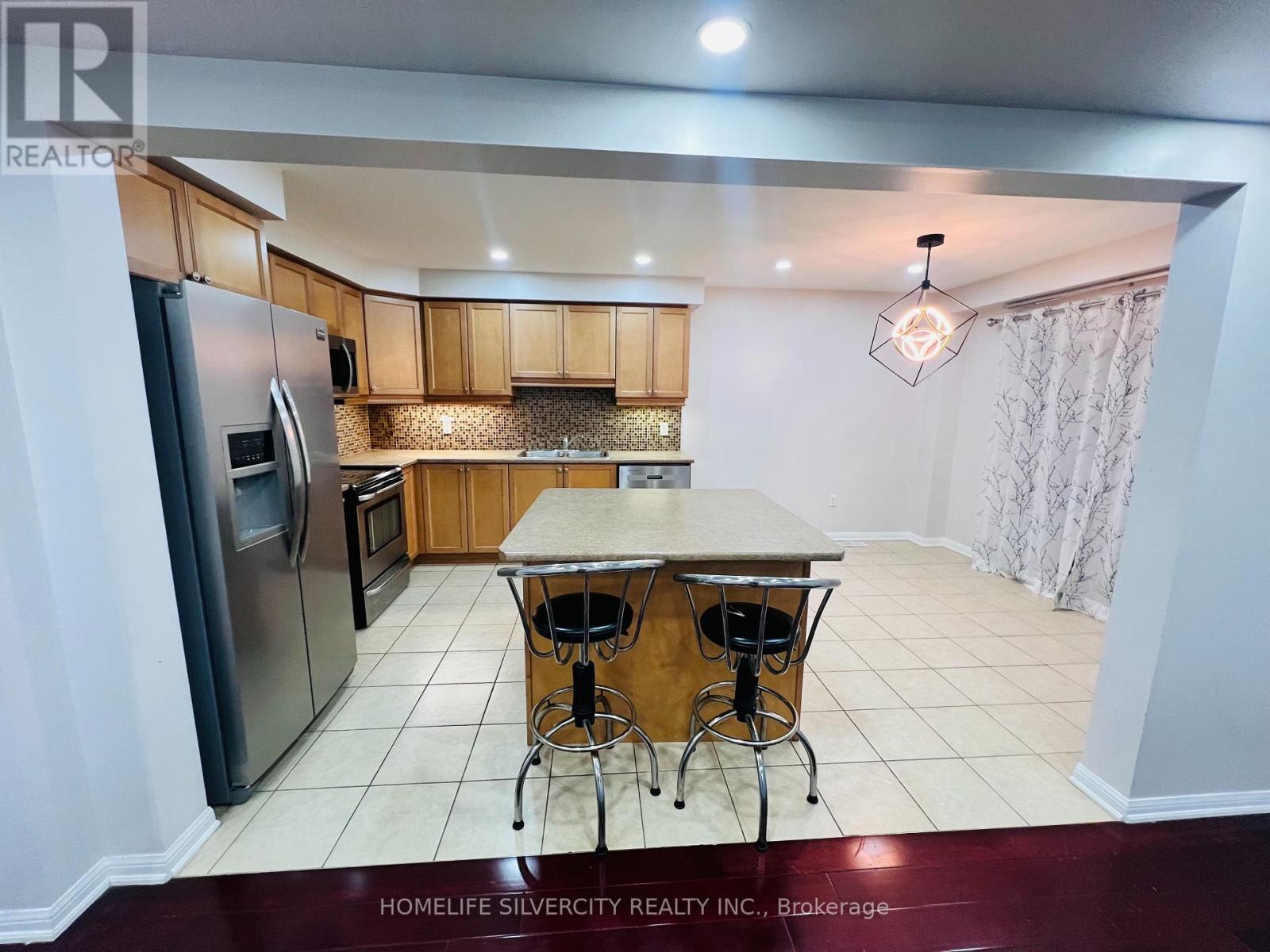 A kitchen with a table and chairs in the middle of the room.