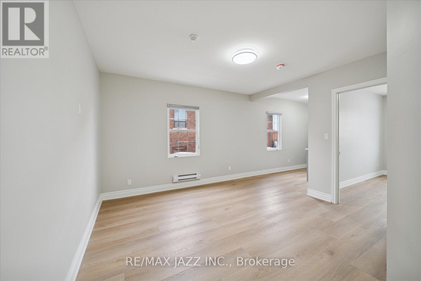 A room with a window and a door is for sale.