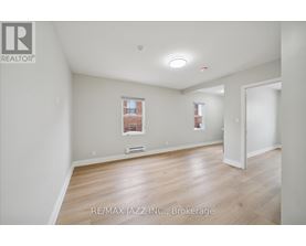 A room with a window and a door is for sale.