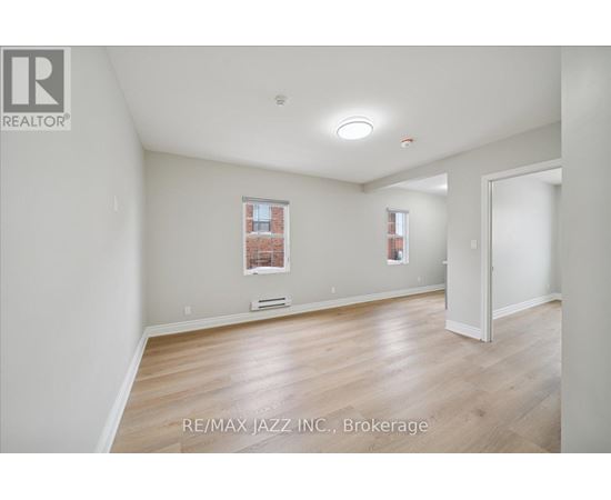 A room with a window and a door is for sale.