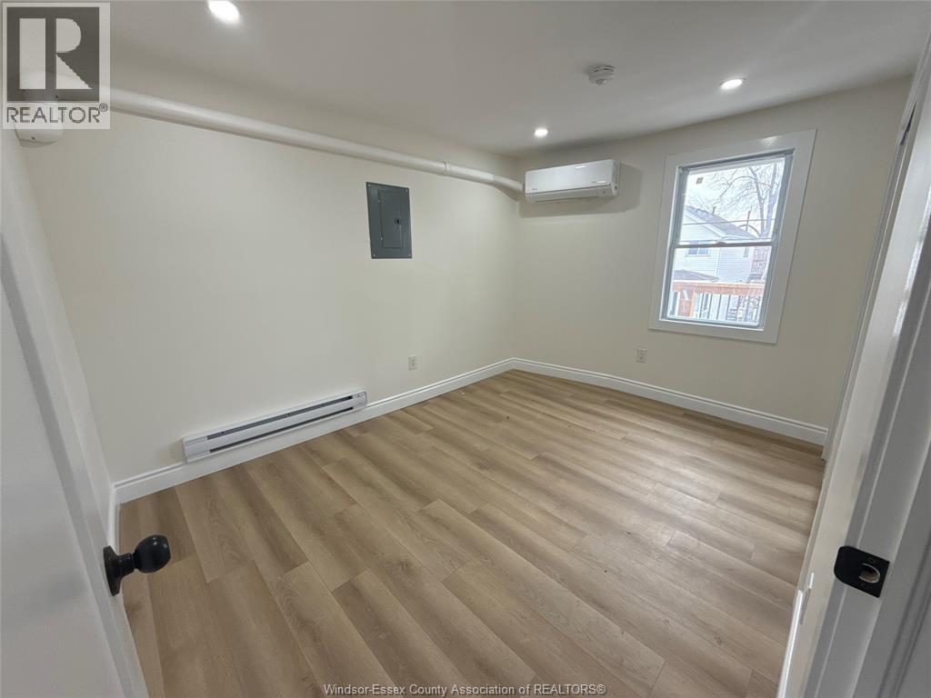 A room with a window and a radiator on the wall.