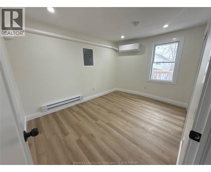 A room with a window and a radiator on the wall.