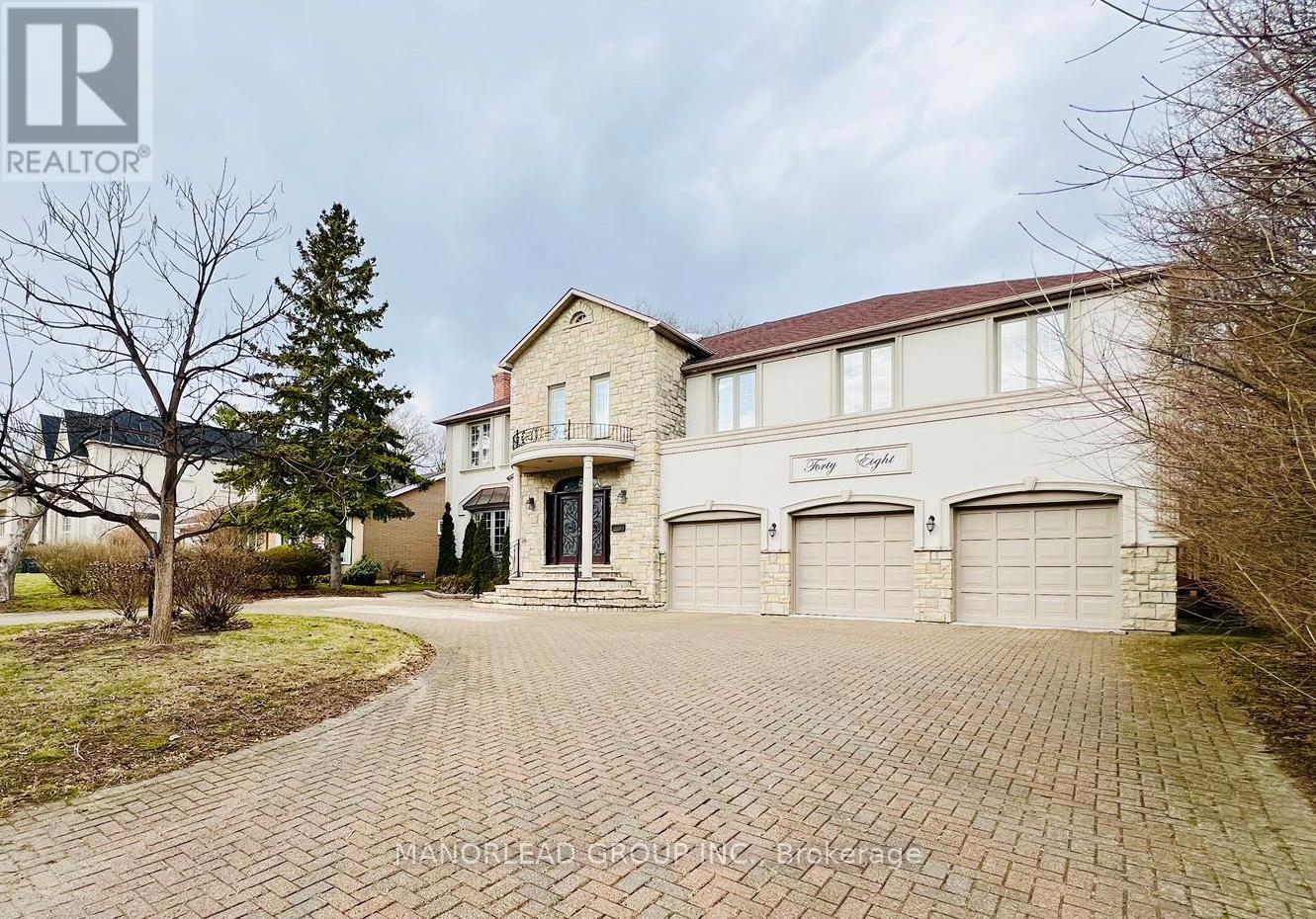 A large house with a driveway in front of it.