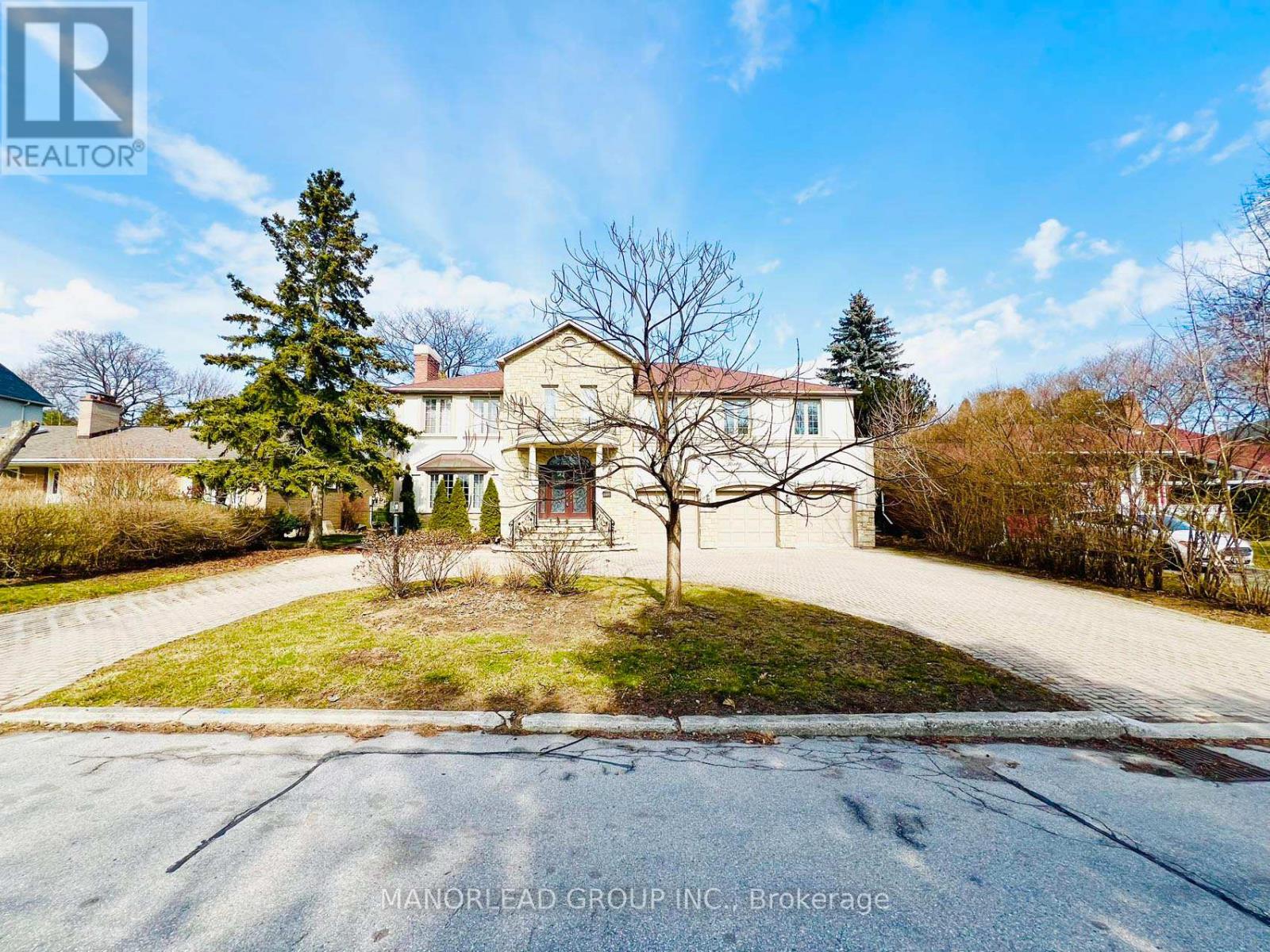 A house with a tree in front of it is for sale.