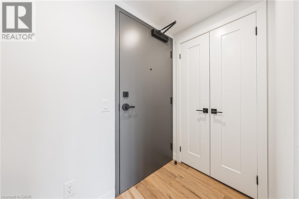 A white door with a black handle and a black latch is on the left side of the image.