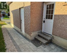 A house with a white door and a brick wall.
