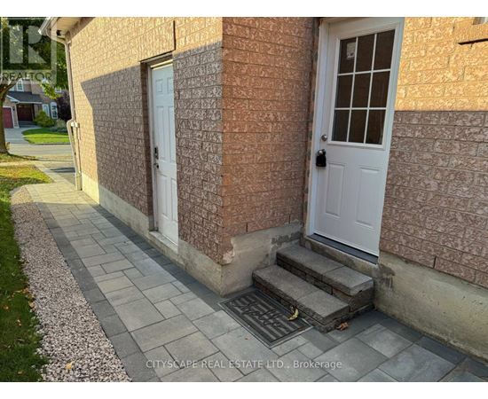 A house with a white door and a brick wall.