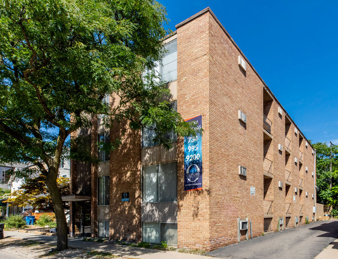 a brick building with a tree in front of it