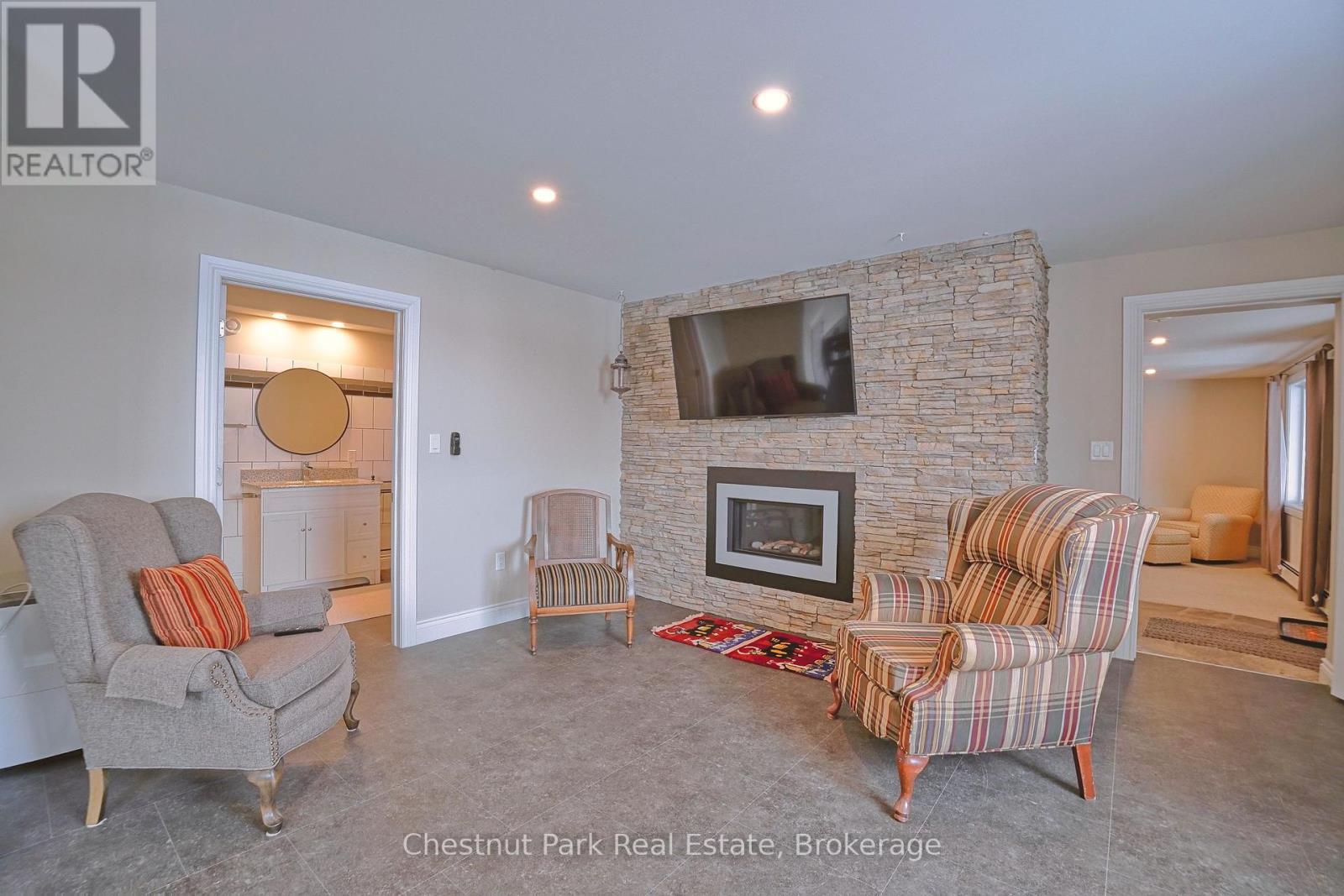 A living room with a fireplace and a flat screen TV.