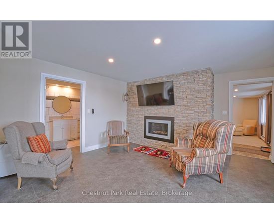 A living room with a fireplace and a flat screen TV.