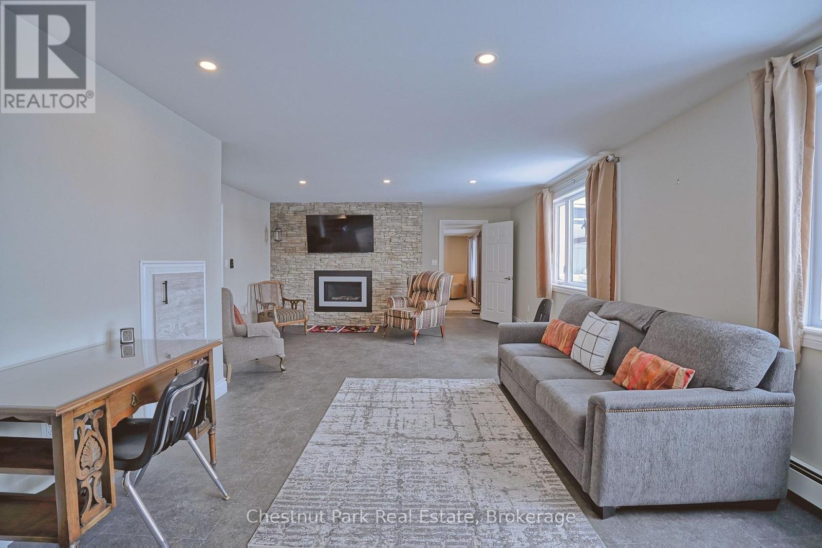 A living room with a grey couch and a wooden table.