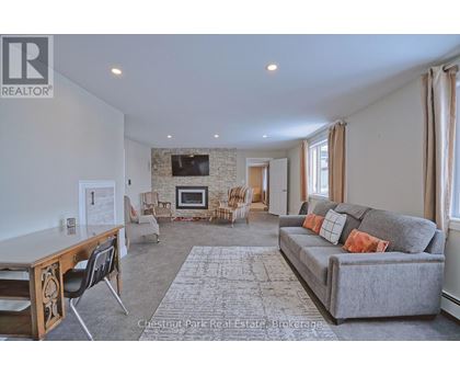 A living room with a grey couch and a wooden table.