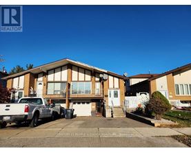 A realtor photo of a house with a white truck parked in front.